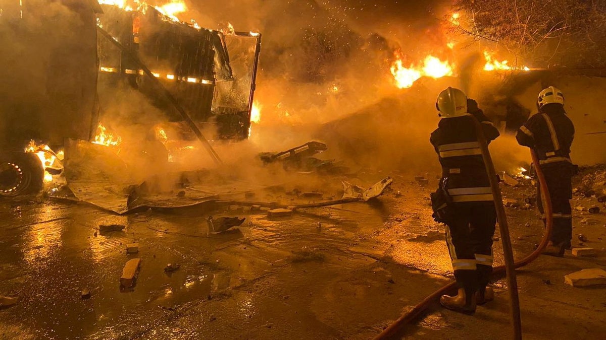 Firefighters extinguish fire in trucks at a site where warehouse facilities were hit during a Russian drone strike, amid Russia's attack on Ukraine, in the village of Murovane, outside of Lviv, Ukraine September 6, 2024.