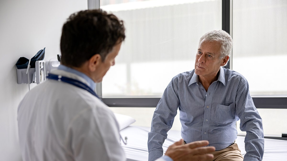 Doctor talking to a patient in a consultaton at his office practice